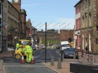 Colas team spray chippings and hot bitumen on Castle Street, Carlisle Colas team spray chippings and hot bitumen on Castle Street, Carlisle