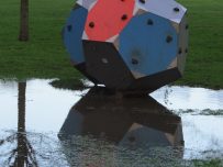 A children's climbing frame surrounded by water