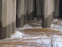 Water gushes under the railway bridges