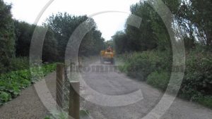 A tipper bounces over the pot holed terrain