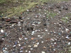 Paths are covered with shards of glass and broken pottery